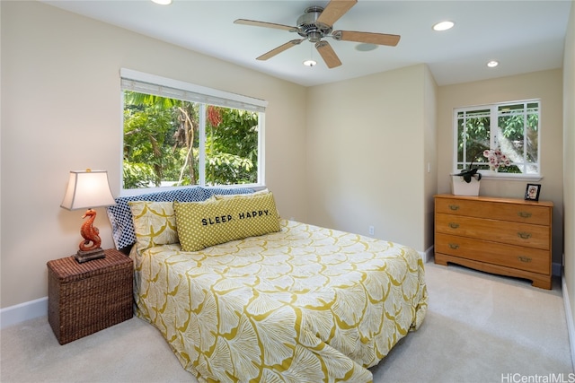 bedroom with light colored carpet and ceiling fan