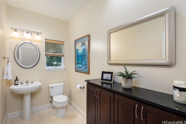 bathroom featuring toilet, tile patterned floors, and sink