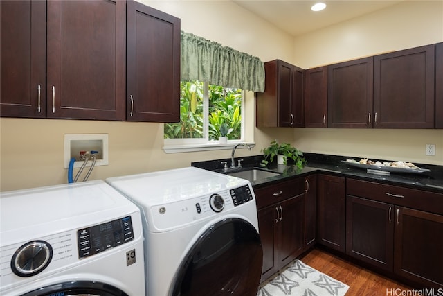 washroom featuring independent washer and dryer, cabinets, sink, and dark hardwood / wood-style floors