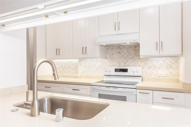 kitchen with white electric range oven, a sink, white cabinetry, exhaust hood, and light countertops
