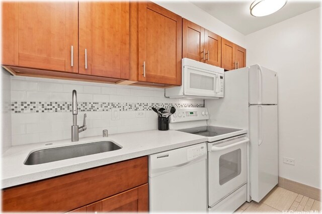 kitchen with light tile patterned floors, sink, white appliances, and tasteful backsplash