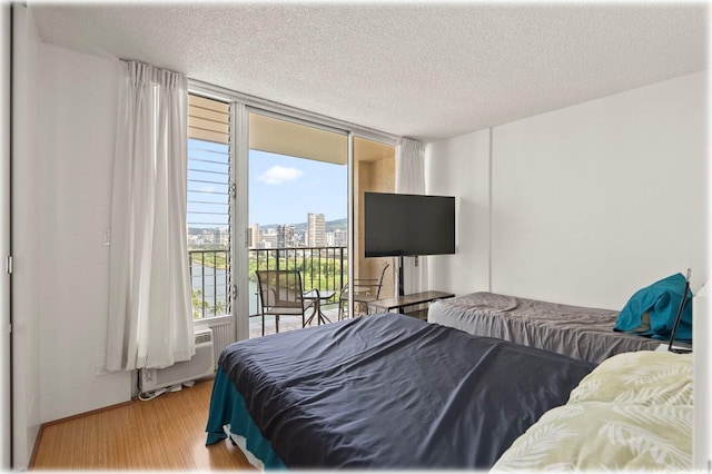2345 Ala Wai Blvd Unit 1814, Honolulu, HI 96815 - bedroom with access to outside, wood finished floors, and a textured ceiling
