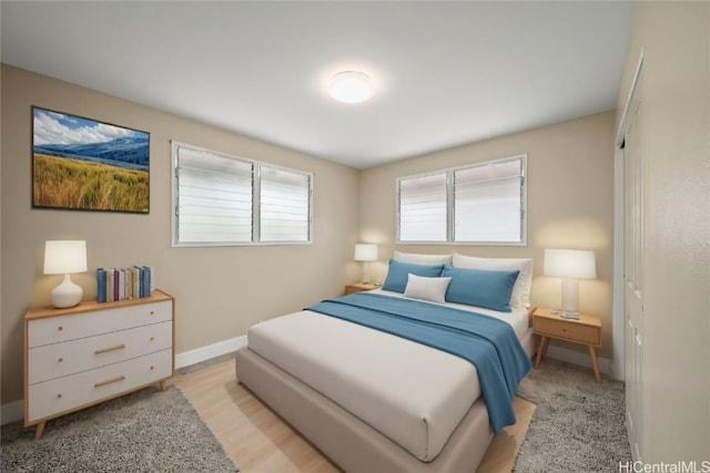 bedroom featuring light wood-type flooring and a closet