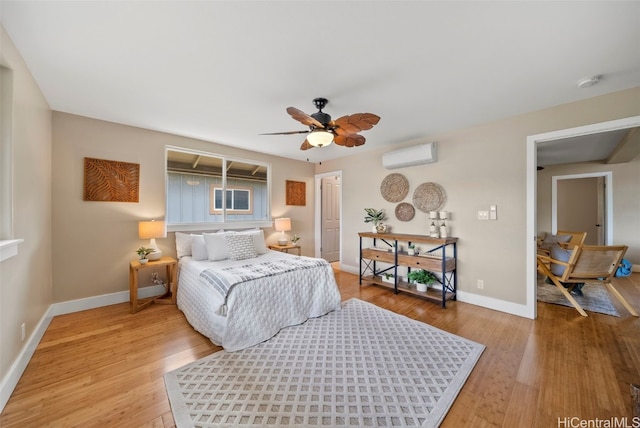 bedroom with a wall mounted AC, ceiling fan, and hardwood / wood-style flooring