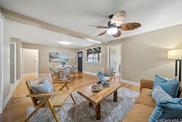 living room featuring ceiling fan and light hardwood / wood-style floors