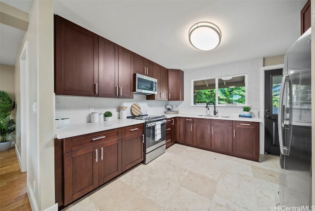 kitchen with sink and appliances with stainless steel finishes