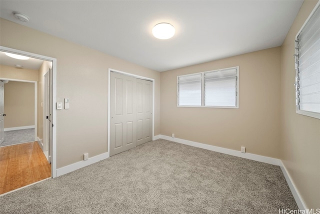 unfurnished bedroom featuring carpet floors and a closet