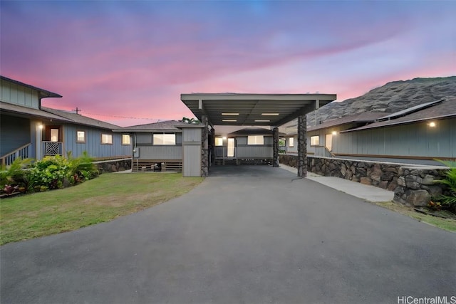 exterior space featuring a lawn and a carport