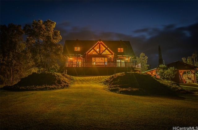 view of front of home featuring a wooden deck and a yard