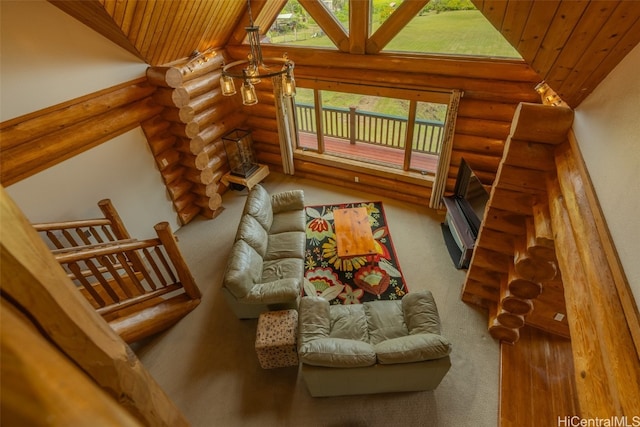 living room with wood ceiling, a healthy amount of sunlight, vaulted ceiling, and rustic walls