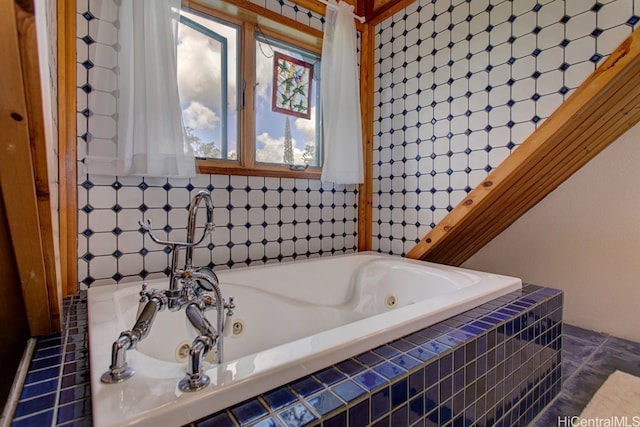 bathroom featuring tiled tub and tile patterned flooring