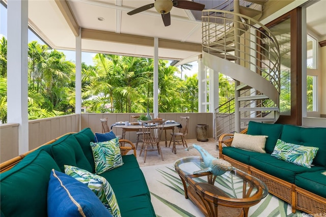 sunroom with a ceiling fan, outdoor dining area, and an outdoor living space