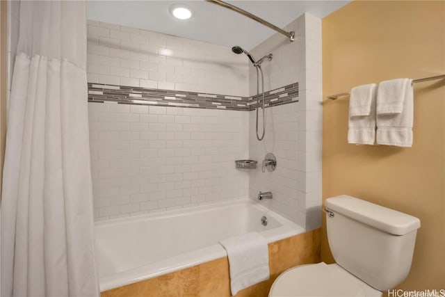 bathroom featuring toilet and shower / tub combo