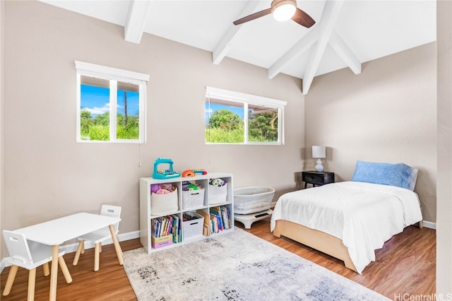 bedroom featuring vaulted ceiling with beams, wood-type flooring, and ceiling fan