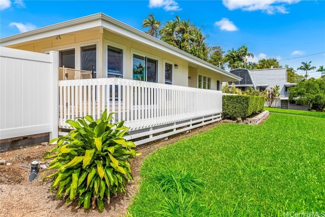 view of side of home featuring a lawn