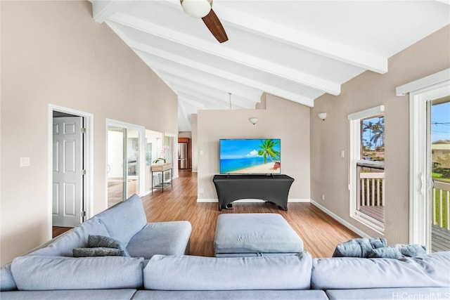 living room with light hardwood / wood-style flooring, a healthy amount of sunlight, and ceiling fan