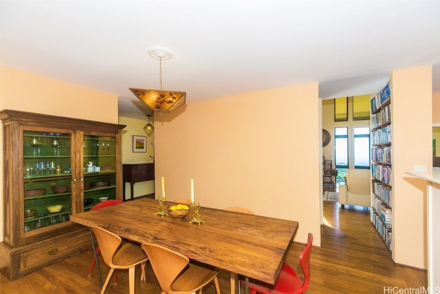 dining space featuring dark wood-type flooring