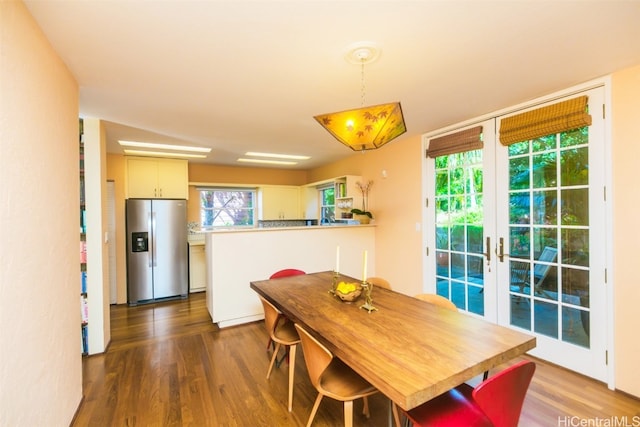 dining room featuring french doors and dark wood-type flooring