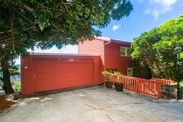 exterior space featuring aphalt driveway and an attached garage