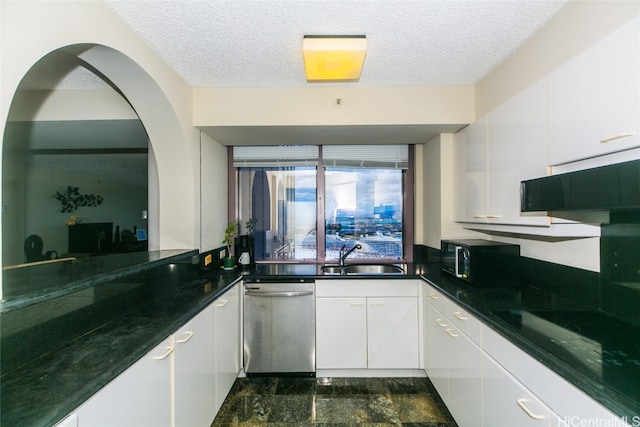 kitchen featuring stovetop, sink, white cabinetry, and dishwasher