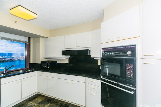 kitchen featuring a textured ceiling, black appliances, sink, and white cabinets