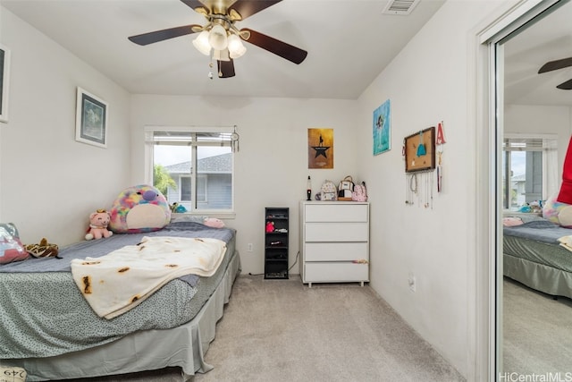 bedroom featuring ceiling fan and light carpet