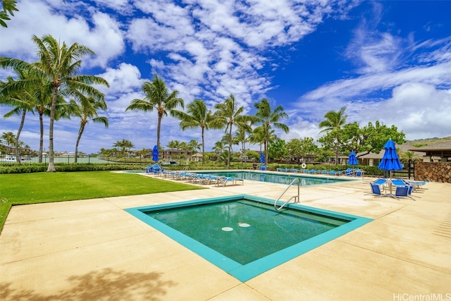 view of swimming pool with a patio area and a yard