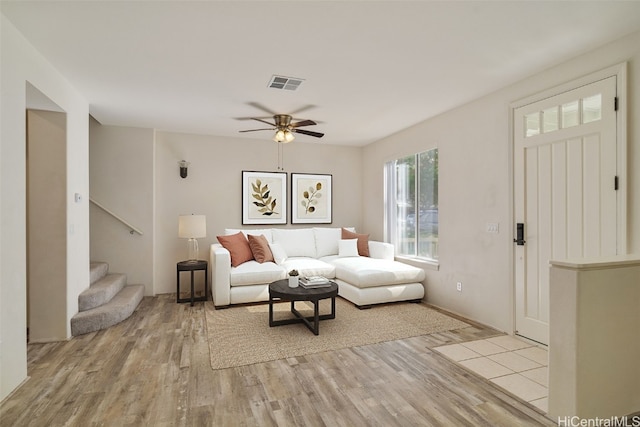 living room featuring ceiling fan and light hardwood / wood-style flooring