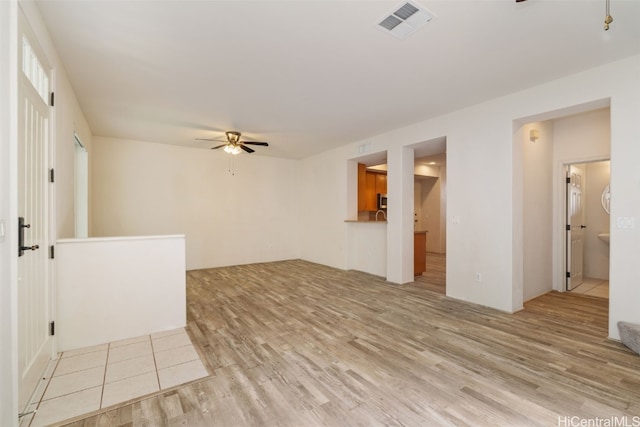 spare room featuring ceiling fan and light hardwood / wood-style floors