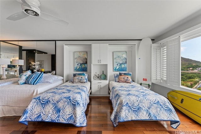 bedroom with wood-type flooring and ceiling fan