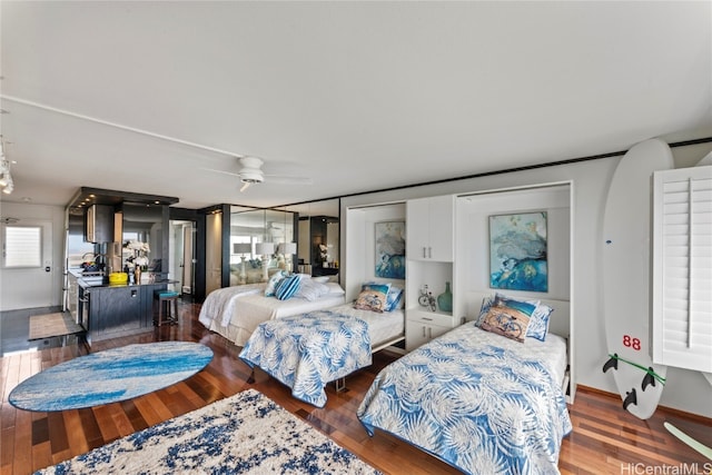 bedroom with ceiling fan and dark hardwood / wood-style floors