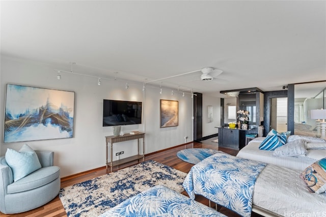 bedroom with hardwood / wood-style flooring and rail lighting