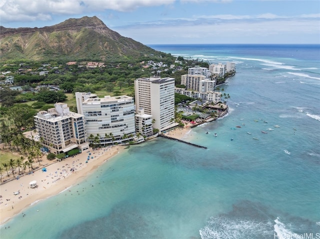 drone / aerial view with a beach view and a water and mountain view