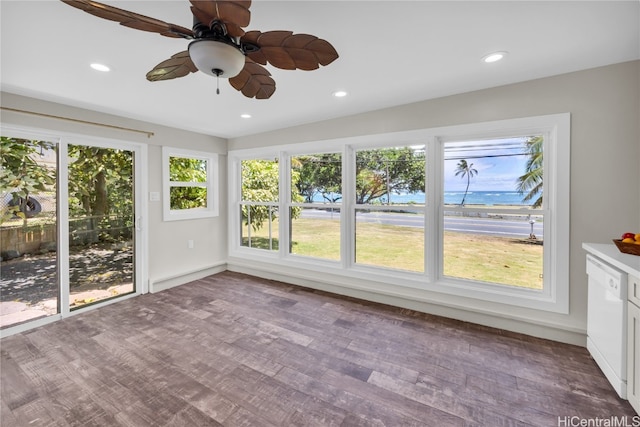 unfurnished sunroom with ceiling fan