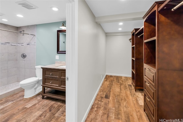 walk in closet with hardwood / wood-style flooring and sink