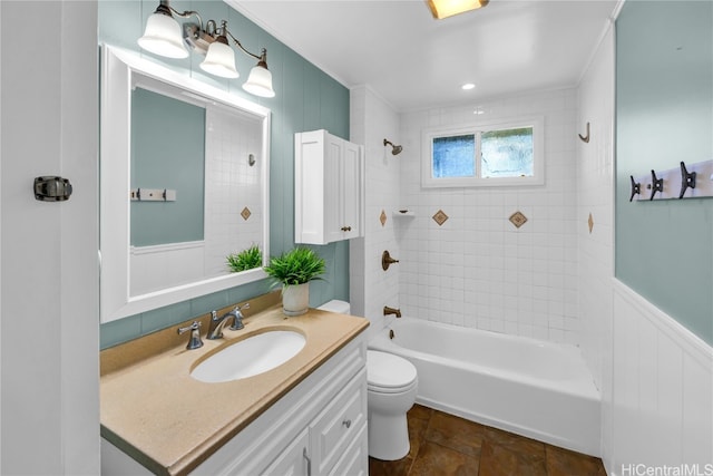 full bathroom featuring vanity, toilet, and tiled shower / bath combo