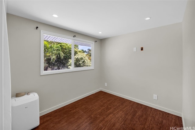 spare room with dark wood-type flooring