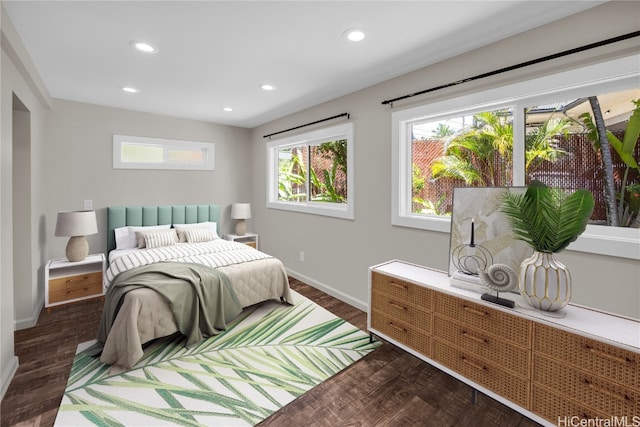 bedroom with dark hardwood / wood-style flooring