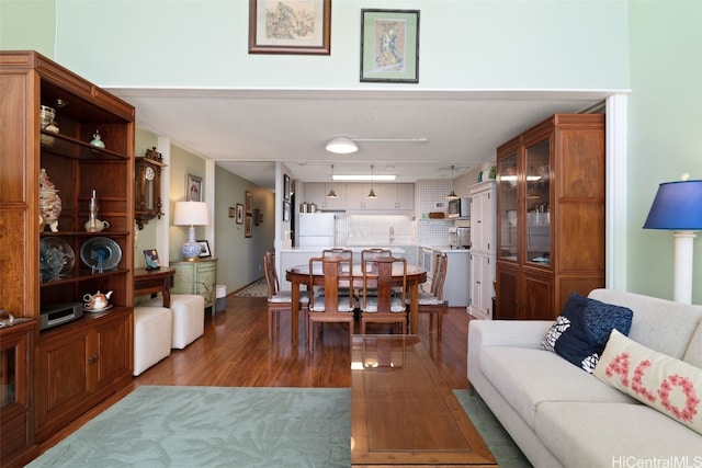 living room featuring dark wood-type flooring and track lighting