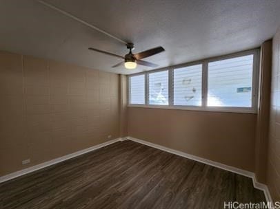 unfurnished room with dark wood-type flooring and ceiling fan