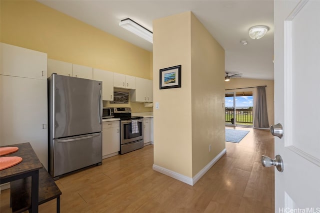 kitchen with light hardwood / wood-style flooring, white cabinets, and appliances with stainless steel finishes