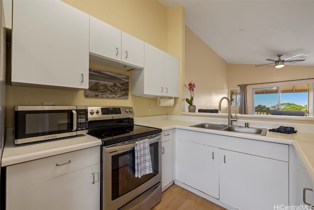 kitchen featuring sink, ceiling fan, stainless steel appliances, light hardwood / wood-style floors, and white cabinets