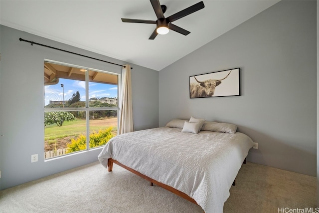 carpeted bedroom with ceiling fan and vaulted ceiling