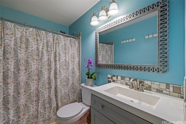 bathroom with tasteful backsplash, vanity, and toilet