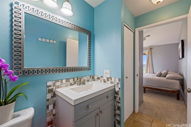 bathroom featuring vanity, toilet, and tile patterned flooring