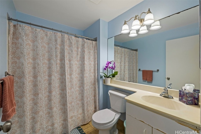 bathroom featuring vanity, tile patterned floors, and toilet