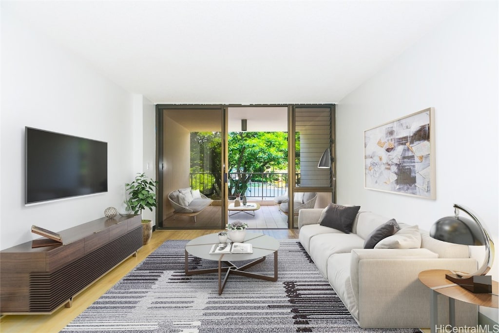 living room featuring expansive windows and light wood-type flooring