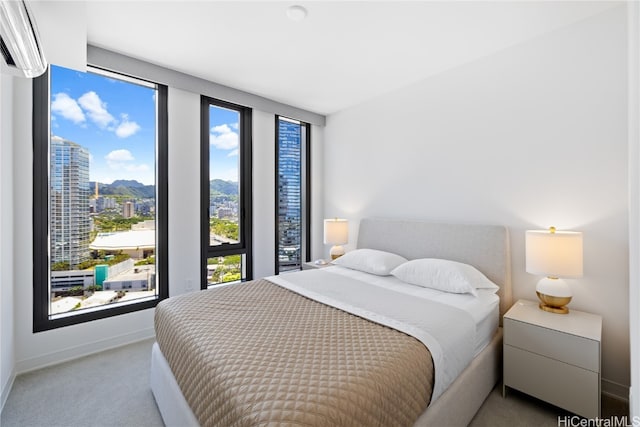 carpeted bedroom featuring a wall mounted AC