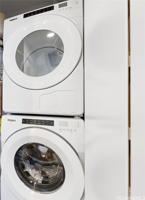 laundry room featuring stacked washer / drying machine