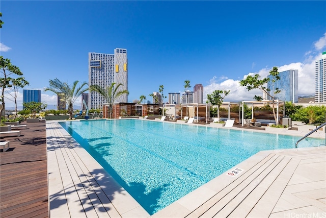 view of swimming pool featuring a pergola and a wooden deck